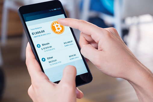 Image: Cryptocurrency trading via mobile app. Image: iStock / Getty Images